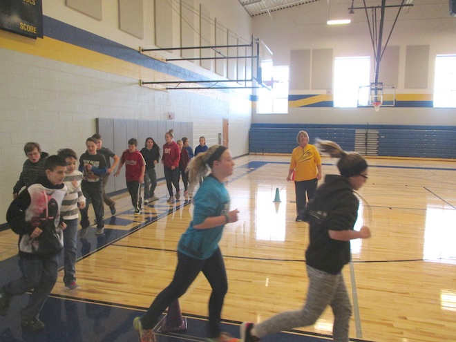 Physical education teacher Sue Rawlins supervises Lakewood students running laps in the school's new gymnasium Monday. The facility was unveiled after eight months of construction (Photo by Jason Arndt)