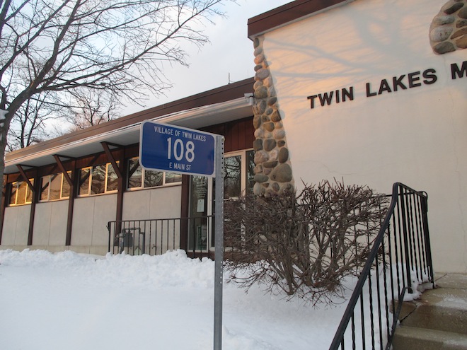The Twin Lakes Village Hall is the first property to receive a uniform address sign in the village. The signs are slated for installation at improved lots beginning in the spring. Bills for $31 each, which includes installation of a galvanized steel post, were sent to property owners with their January sewer bill (Photo by Jason Arndt).