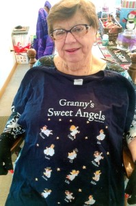 Virginia Gnat, former Twin Lakes Report “Young at Heart” senior columnist proudly displays a sweatshirt containing the names of all 12 of her great grandchildren (Photo Submitted).